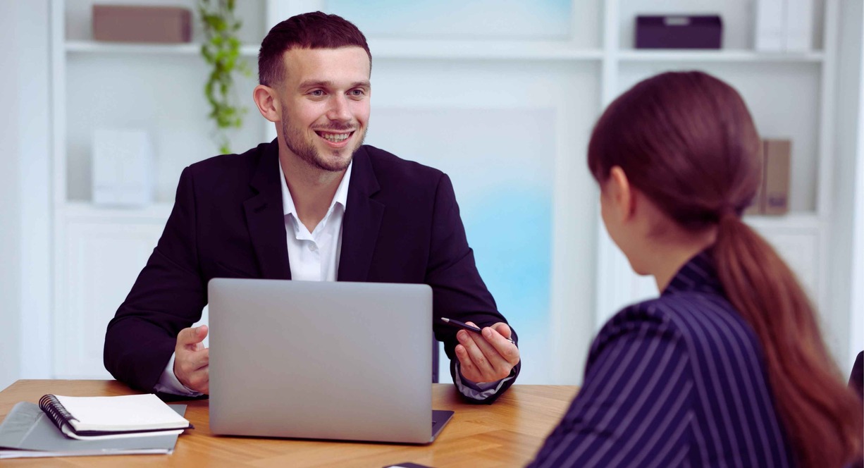 Consultant travaillant avec un client autour d'une table en réunion professionnelle
