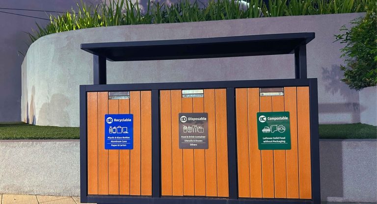 Poubelles de tri sélectif colorées alignées en extérieur pour la collecte des ordures ménagères