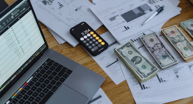 Calculatrice billets et documents financiers sur un bureau